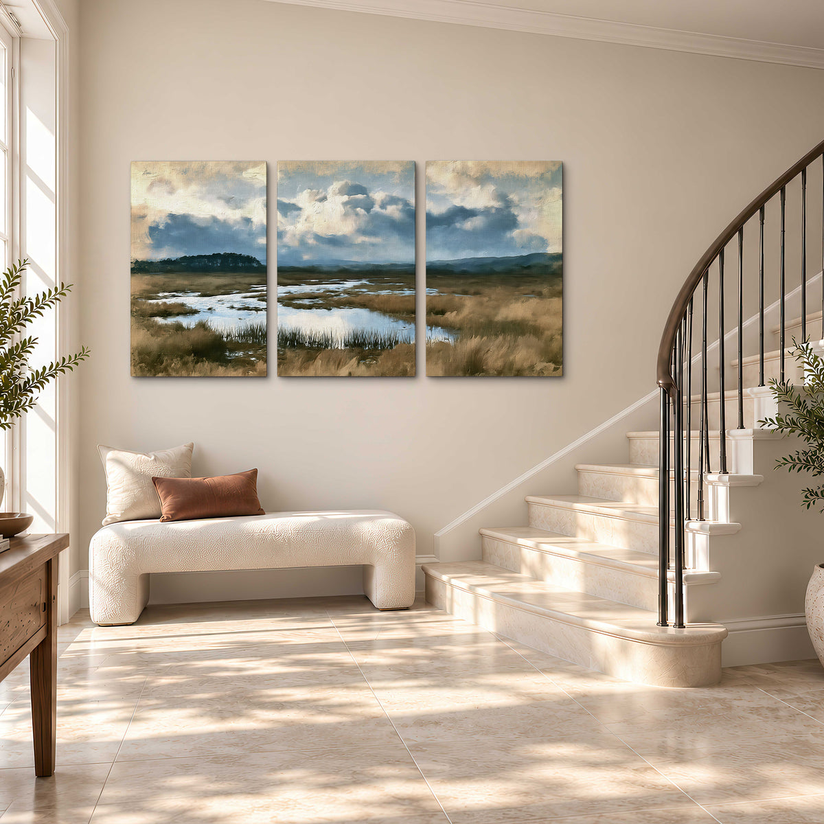 A wide open marsh with blue water and warm grasses beneath layered clouds 3 piece canvas wall art styled in an interior