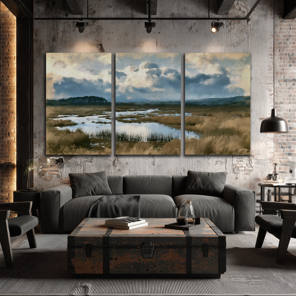 A wide open marsh with blue water and warm grasses beneath layered clouds 3 piece canvas wall art displayed in a industrial room