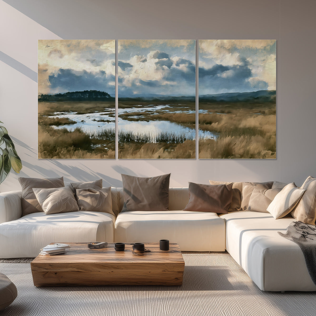 A wide open marsh with blue water and warm grasses beneath layered clouds set of 3 poster prints displayed in a living room