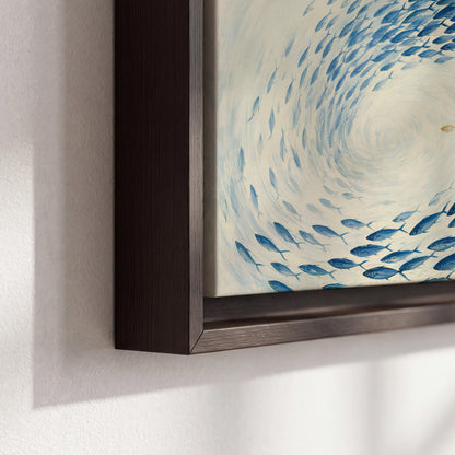 A circular school of blue fish flowing around a pale open center 3 piece framed canvas wall art material and edge close up
