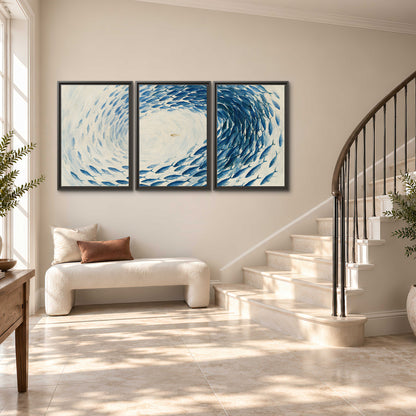 A circular school of blue fish flowing around a pale open center 3 piece framed canvas wall art styled in an interior