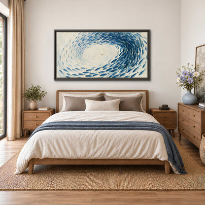 A circular school of blue fish flowing around a pale open center single framed canvas wall art styled in an interior