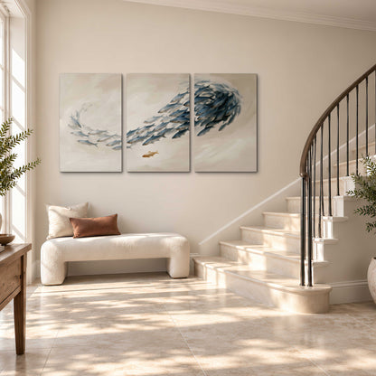 A sweeping school of small gray fish curving across a pale neutral background 3 piece canvas wall art styled in an interior