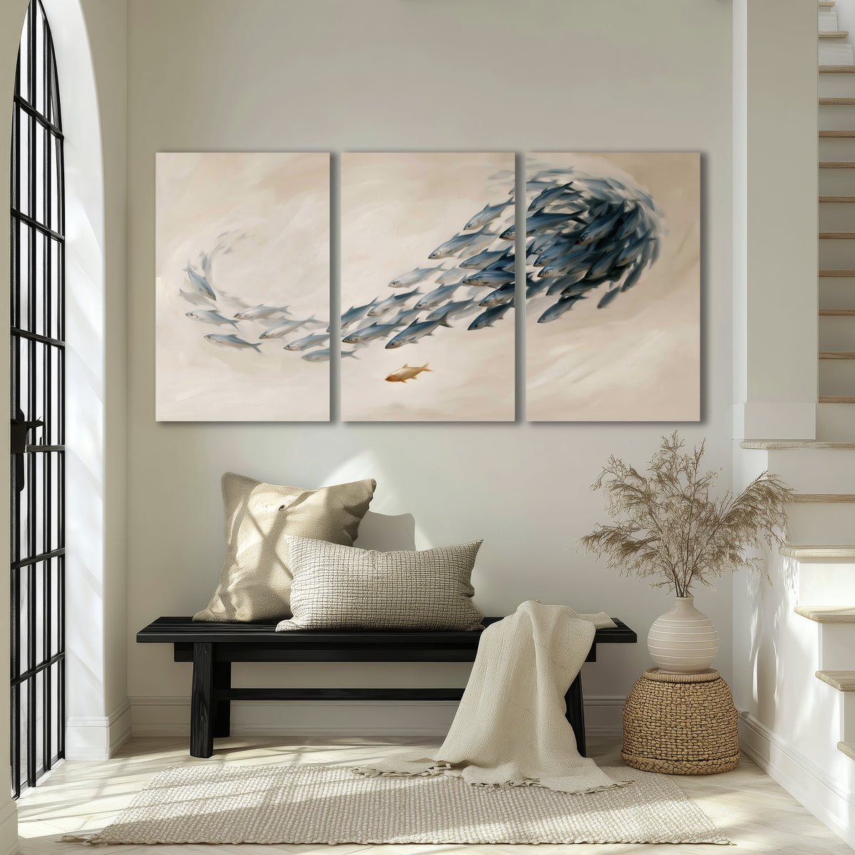 A sweeping school of small gray fish curving across a pale neutral background 3 piece canvas wall art displayed in a entryway