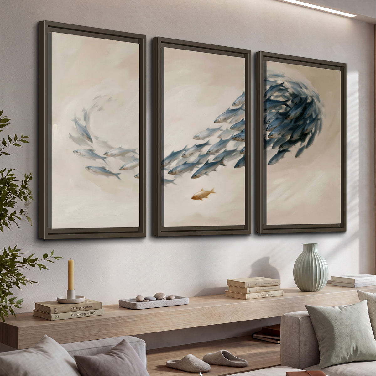 A sweeping school of small gray fish curving across a pale neutral background 3 piece framed canvas wall art displayed in a console