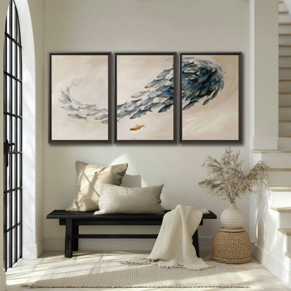 A sweeping school of small gray fish curving across a pale neutral background 3 piece framed canvas wall art displayed in a entryway