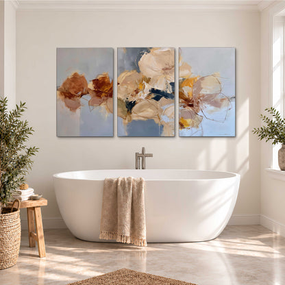 Loose ivory and ochre flower forms layered over a pale blue painterly background 3 piece canvas wall art styled in an interior
