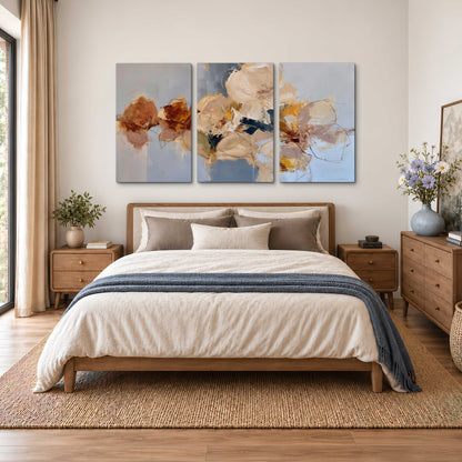 Loose ivory and ochre flower forms layered over a pale blue painterly background 3 piece canvas wall art styled in an interior