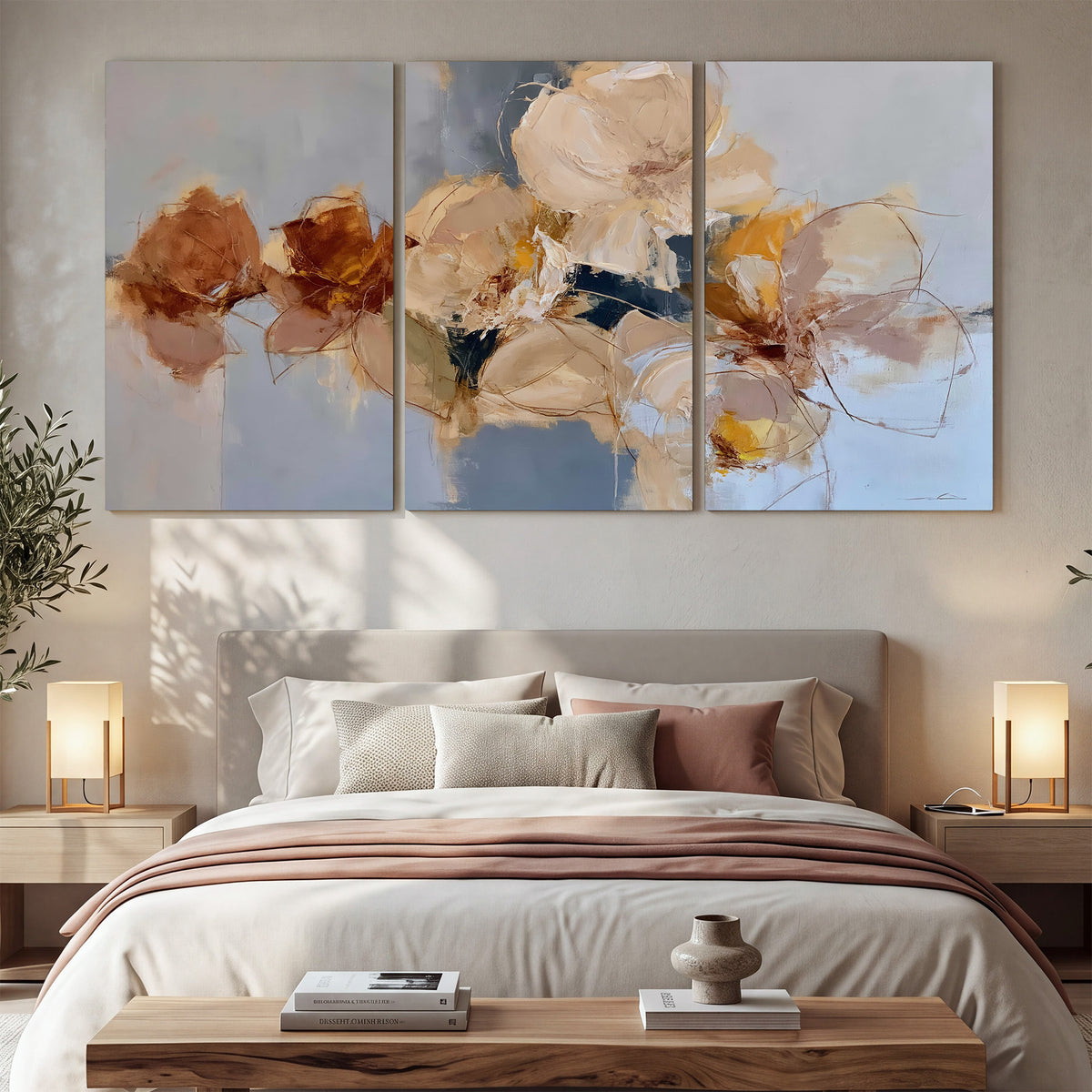 Loose ivory and ochre flower forms layered over a pale blue painterly background 3 piece canvas wall art displayed in a bedroom