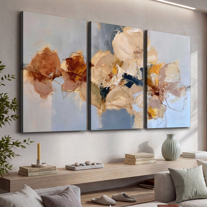 Loose ivory and ochre flower forms layered over a pale blue painterly background 3 piece canvas wall art displayed in a console