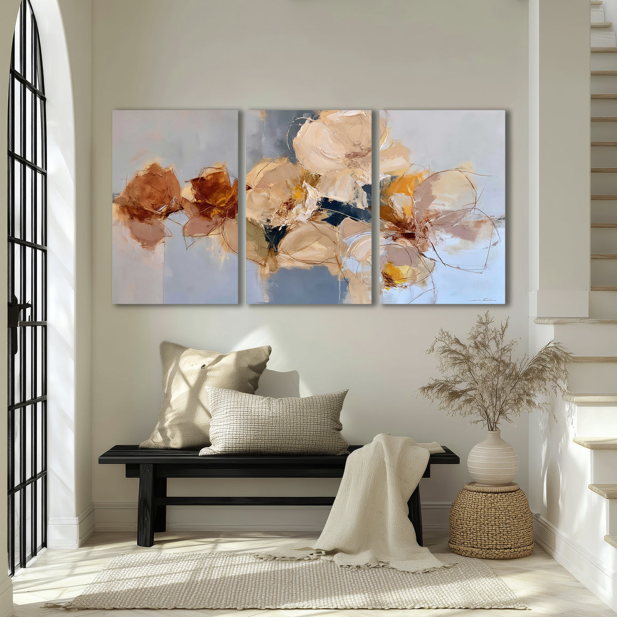 Loose ivory and ochre flower forms layered over a pale blue painterly background 3 piece canvas wall art displayed in a entryway