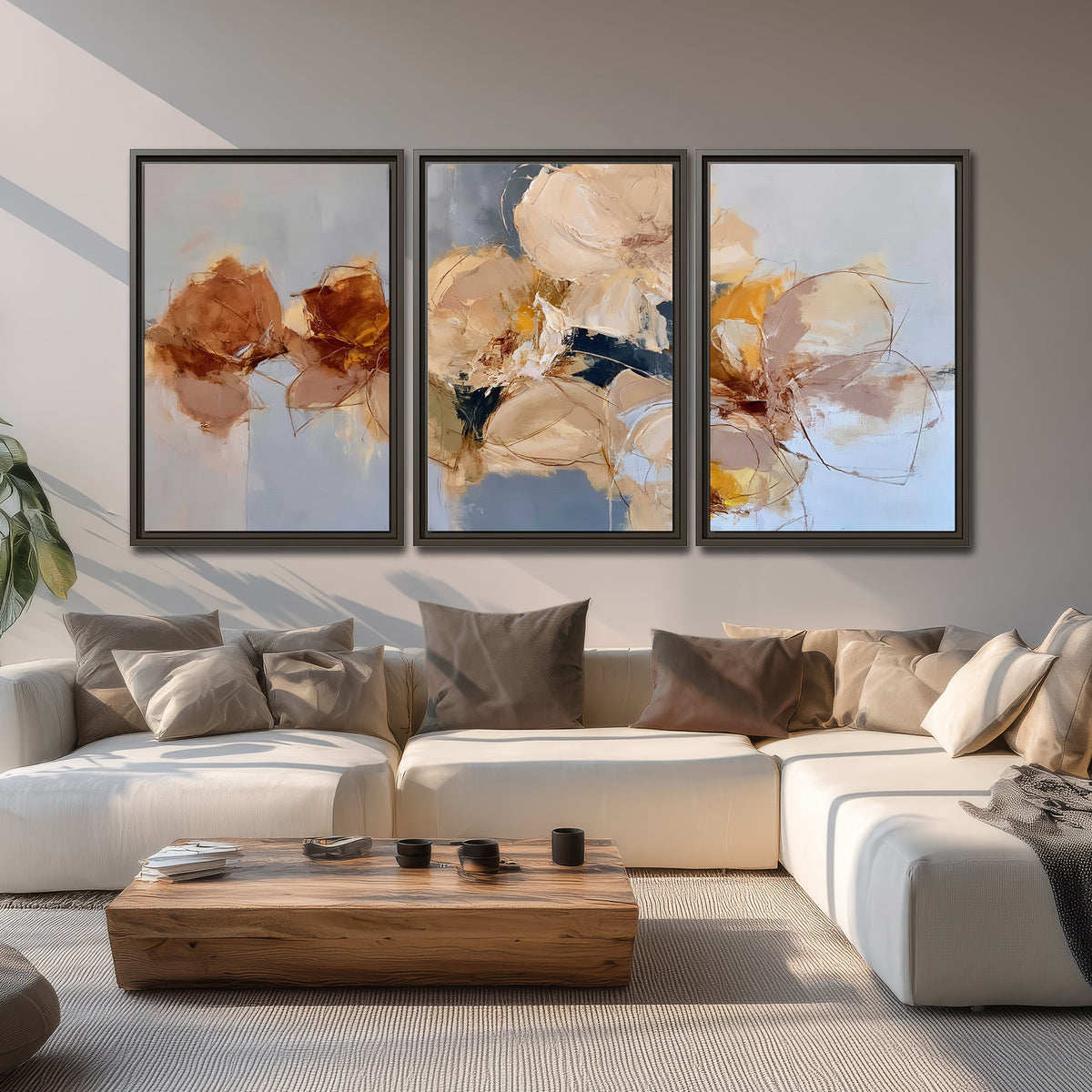 Loose ivory and ochre flower forms layered over a pale blue painterly background 3 piece framed canvas wall art displayed in a living room