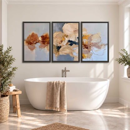 Loose ivory and ochre flower forms layered over a pale blue painterly background 3 piece framed canvas wall art styled in an interior