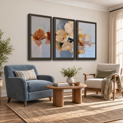 Loose ivory and ochre flower forms layered over a pale blue painterly background 3 piece framed canvas wall art styled in an interior