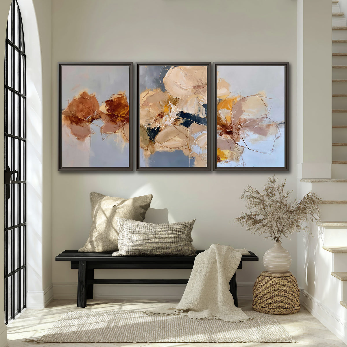 Loose ivory and ochre flower forms layered over a pale blue painterly background 3 piece framed canvas wall art displayed in a entryway