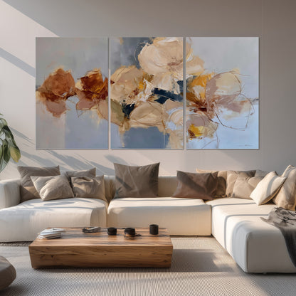 Loose ivory and ochre flower forms layered over a pale blue painterly background set of 3 poster prints displayed in a living room