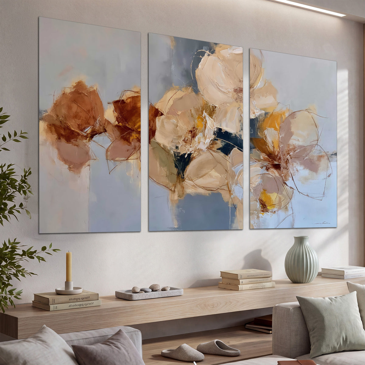 Loose ivory and ochre flower forms layered over a pale blue painterly background set of 3 poster prints displayed in a console