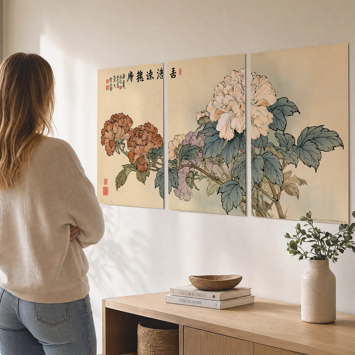 Pale pink peonies and green leaves on a warm beige background with decorative script set of 3 poster prints three panel arrangement on a wall
