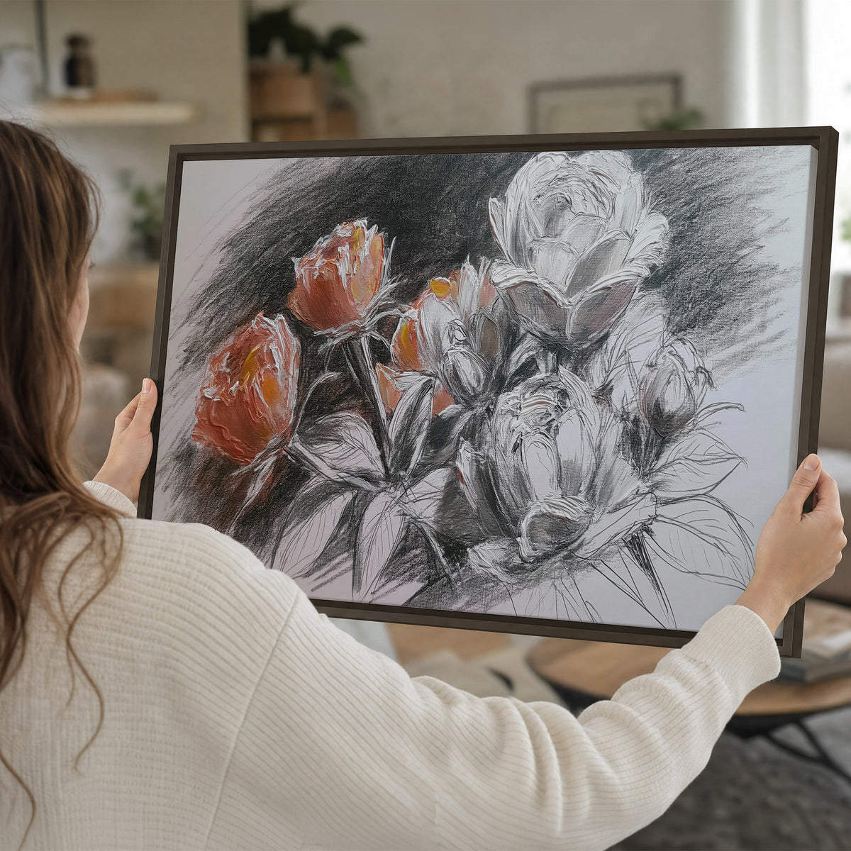 Expressive charcoal-style roses with muted rust petals against a textured-look gray background single framed canvas wall art held in hands