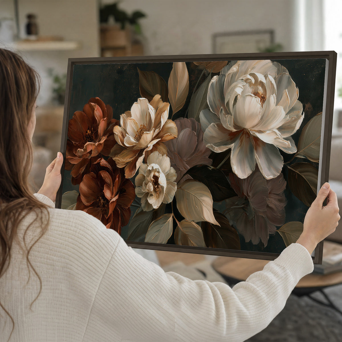 Large ivory roses and warm rust blooms against a deep shadowed background single framed canvas wall art held in hands