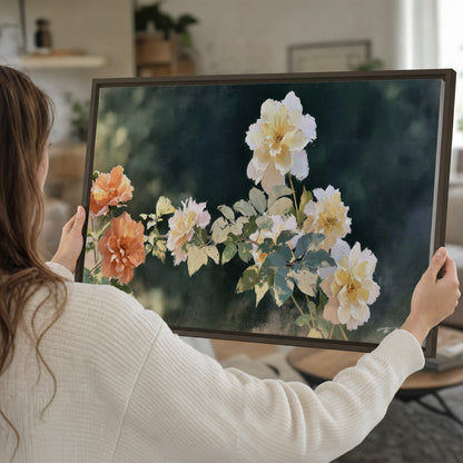 White and peach roses with green leaves against a deep blue-green background single framed canvas wall art held in hands