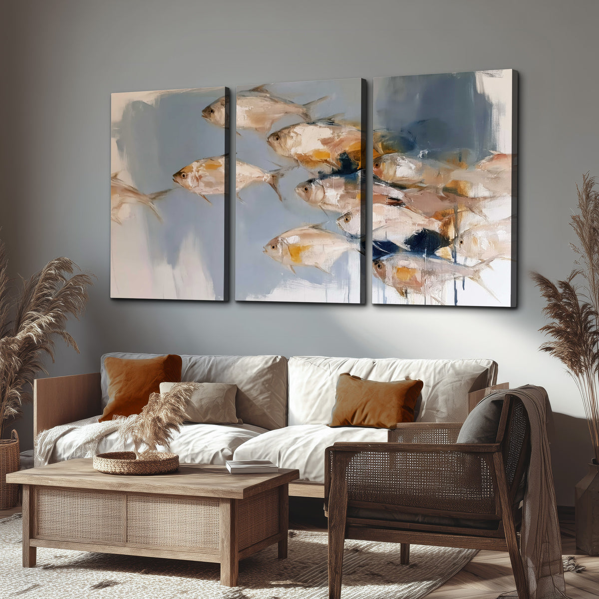 Small blue and golden fish moving across a pale layered abstract background 3 piece canvas wall art displayed in a rustic living room