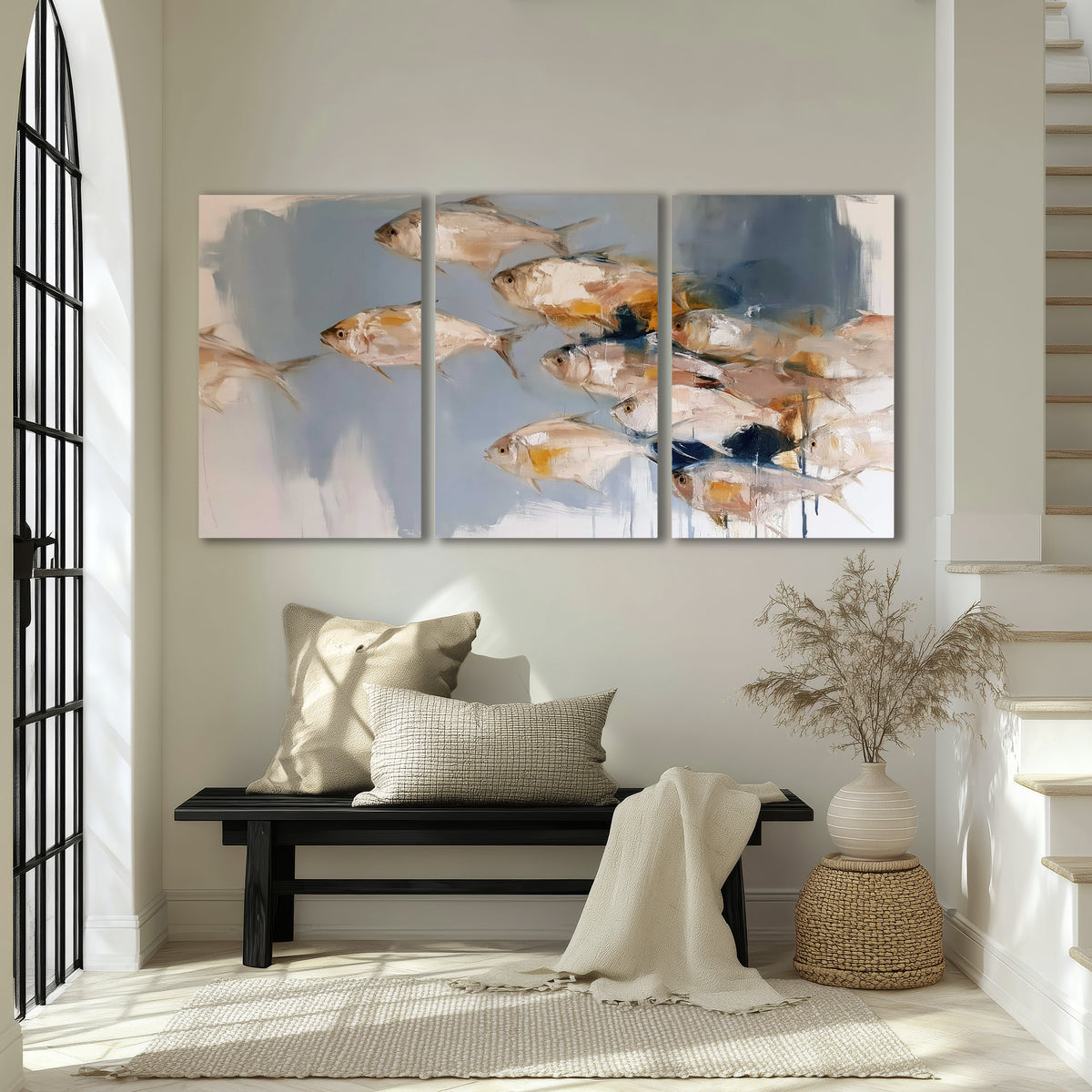 Small blue and golden fish moving across a pale layered abstract background 3 piece canvas wall art displayed in a entryway