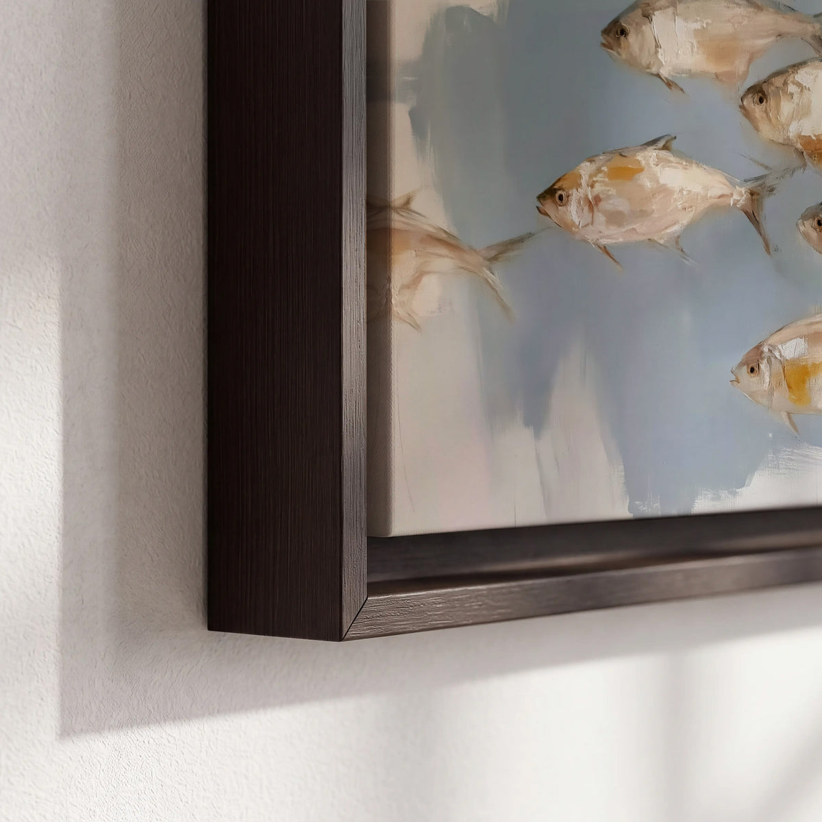 Small blue and golden fish moving across a pale layered abstract background 3 piece framed canvas wall art material and edge close up