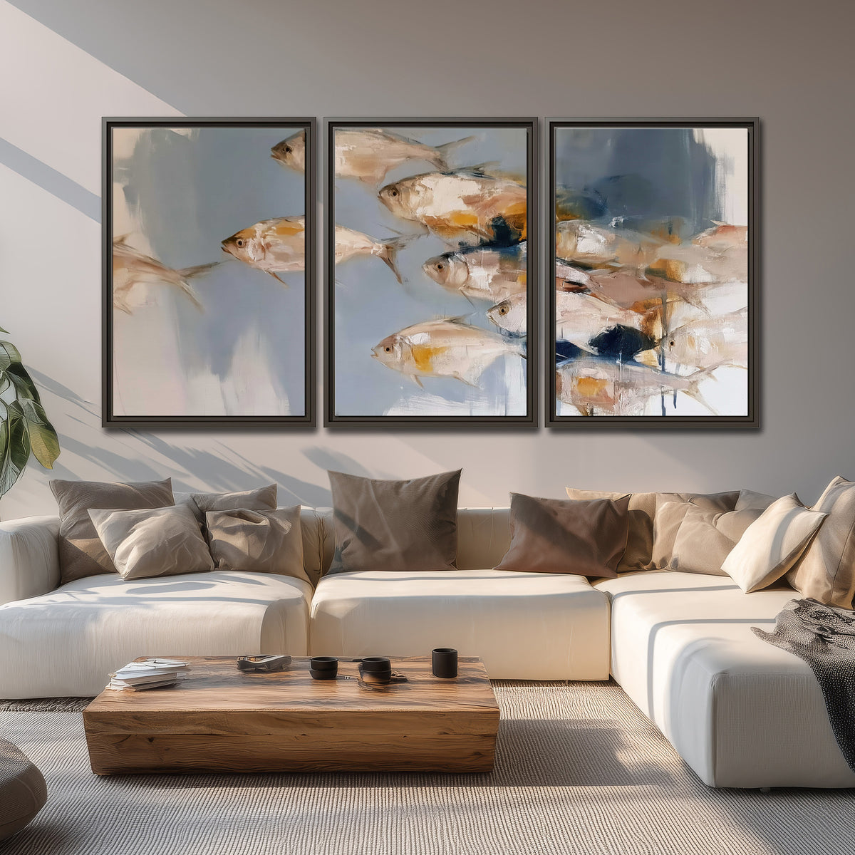 Small blue and golden fish moving across a pale layered abstract background 3 piece framed canvas wall art displayed in a living room