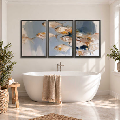 Small blue and golden fish moving across a pale layered abstract background 3 piece framed canvas wall art styled in an interior