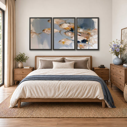Small blue and golden fish moving across a pale layered abstract background 3 piece framed canvas wall art styled in an interior