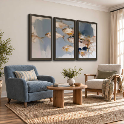 Small blue and golden fish moving across a pale layered abstract background 3 piece framed canvas wall art styled in an interior