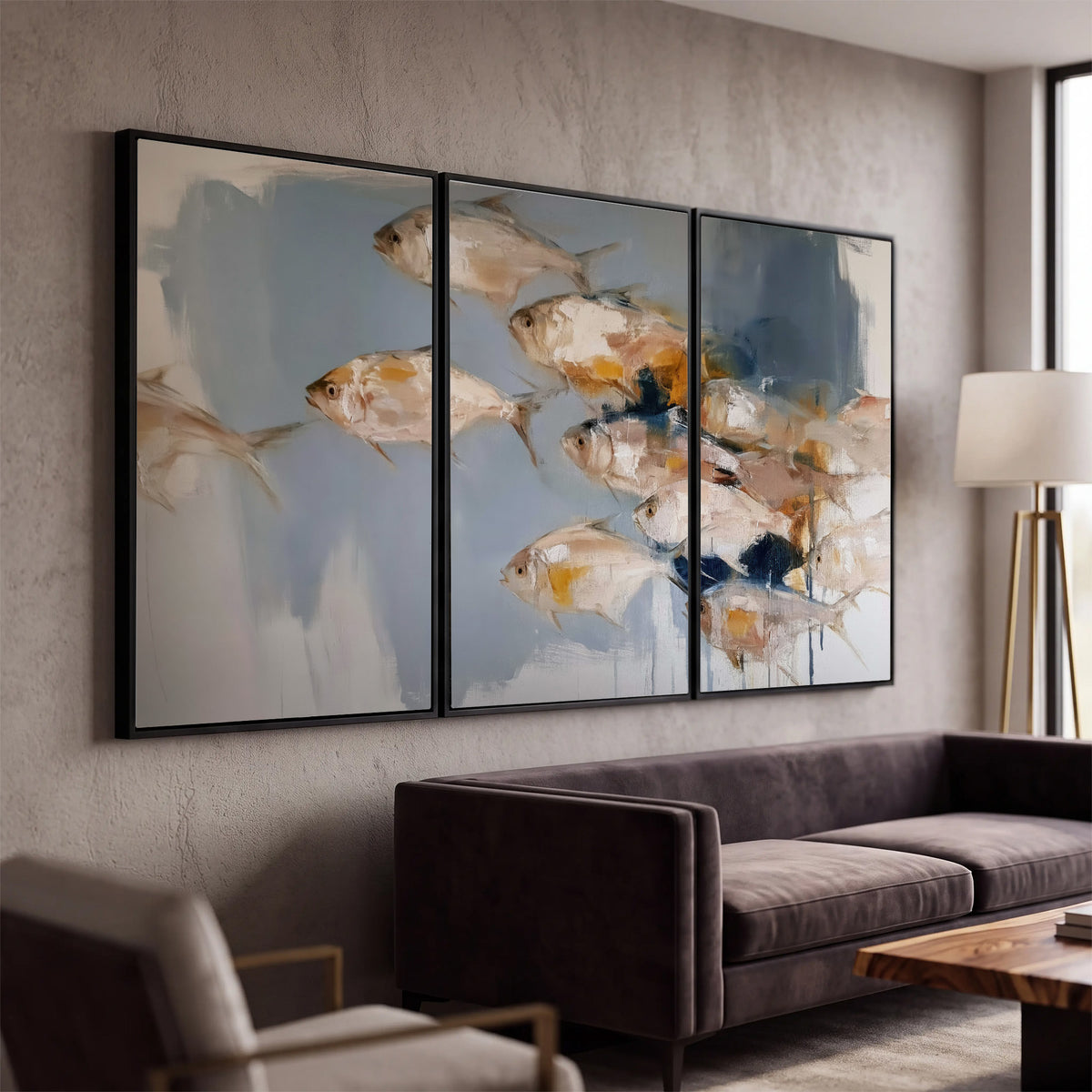 Small blue and golden fish moving across a pale layered abstract background 3 piece framed canvas wall art displayed in a modern living room