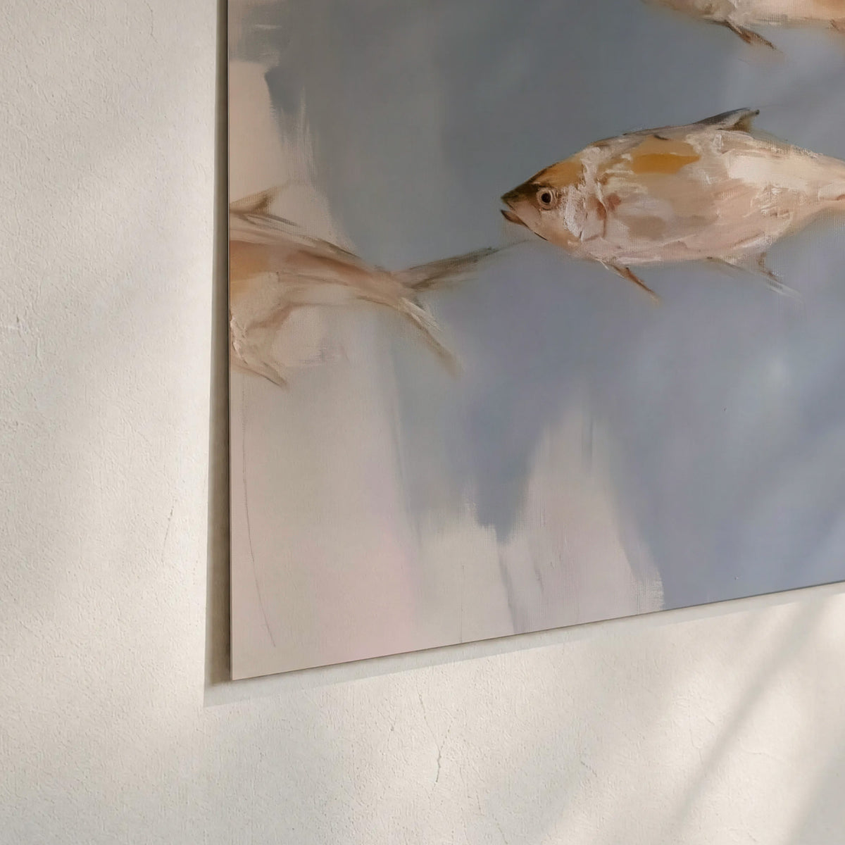 Small blue and golden fish moving across a pale layered abstract background set of 3 poster prints material and edge close up