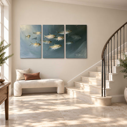 A small school of pale golden fish swimming across dark blue-green water 3 piece canvas wall art styled in an interior