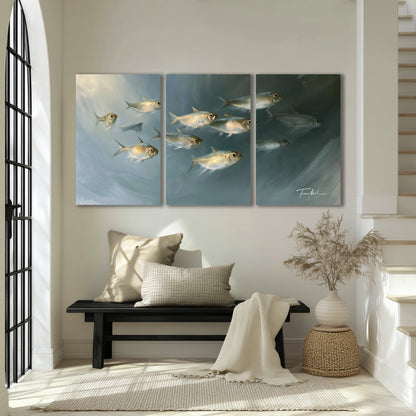 A small school of pale golden fish swimming across dark blue-green water 3 piece canvas wall art displayed in a entryway