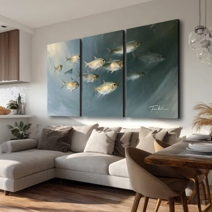 A small school of pale golden fish swimming across dark blue-green water 3 piece canvas wall art room and product view