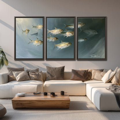 A small school of pale golden fish swimming across dark blue-green water 3 piece framed canvas wall art displayed in a living room