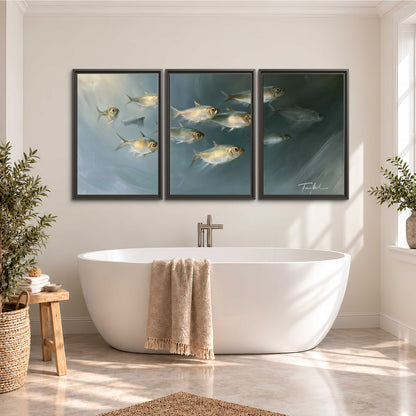 A small school of pale golden fish swimming across dark blue-green water 3 piece framed canvas wall art styled in an interior