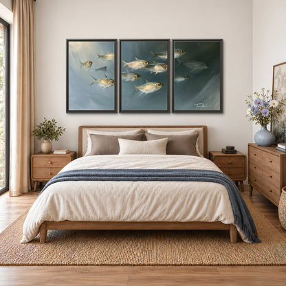 A small school of pale golden fish swimming across dark blue-green water 3 piece framed canvas wall art styled in an interior