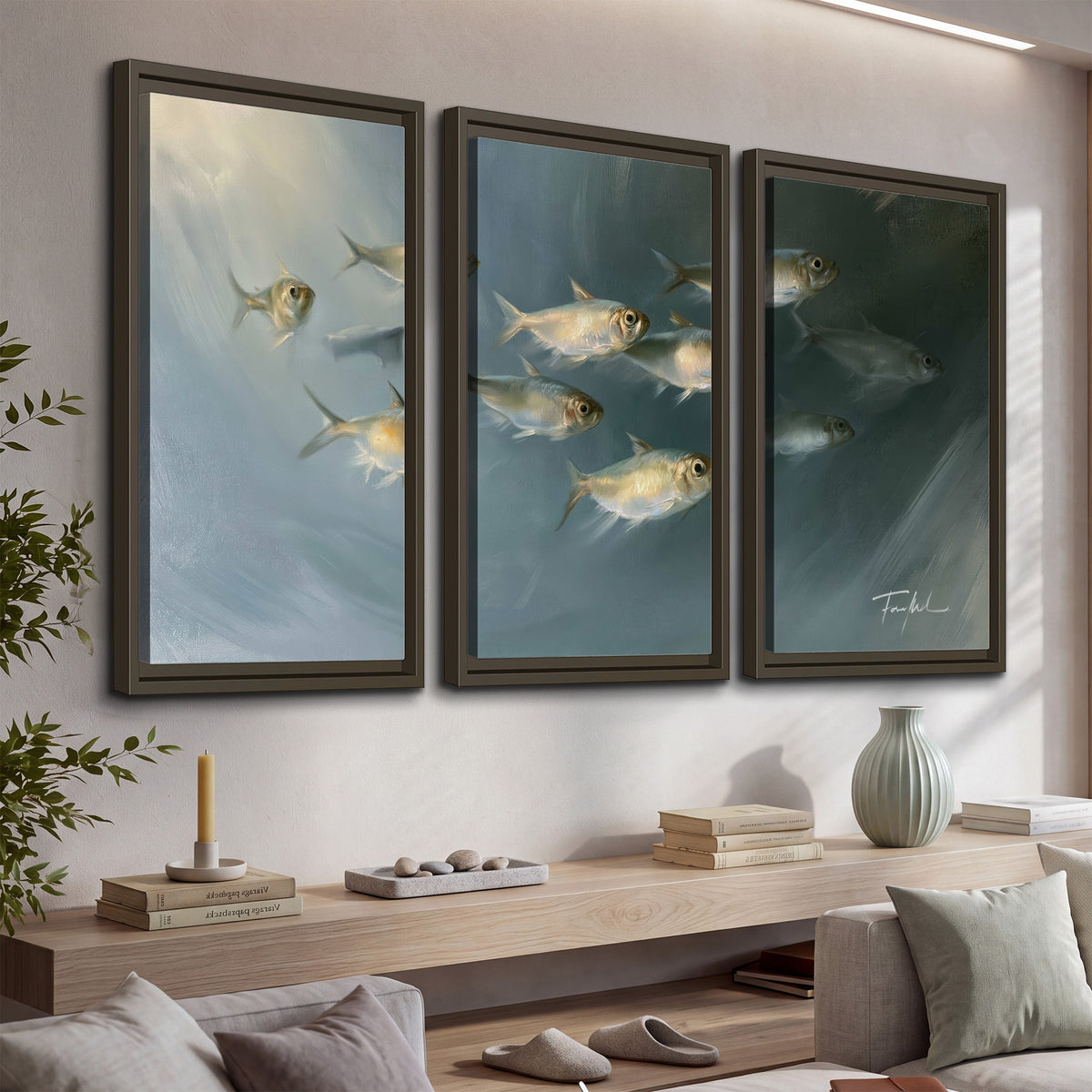 A small school of pale golden fish swimming across dark blue-green water 3 piece framed canvas wall art displayed in a console