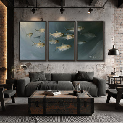 A small school of pale golden fish swimming across dark blue-green water 3 piece framed canvas wall art displayed in a industrial room