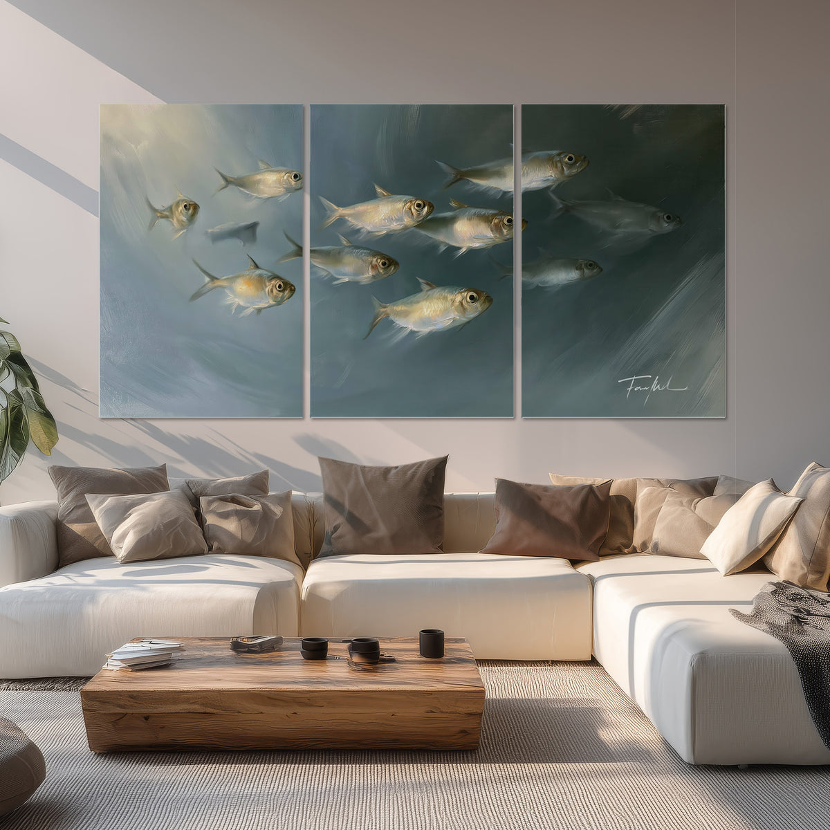 A small school of pale golden fish swimming across dark blue-green water set of 3 poster prints displayed in a living room