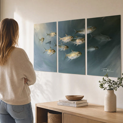A small school of pale golden fish swimming across dark blue-green water set of 3 poster prints three panel arrangement on a wall