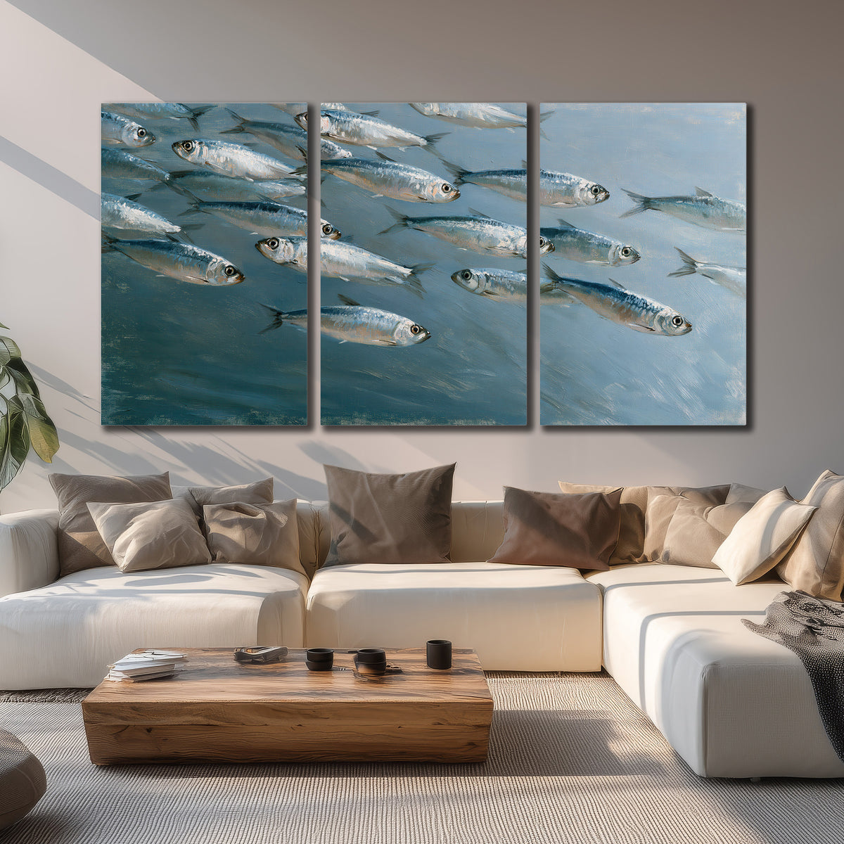 A school of silver fish moving together through cool blue water 3 piece canvas wall art displayed in a living room