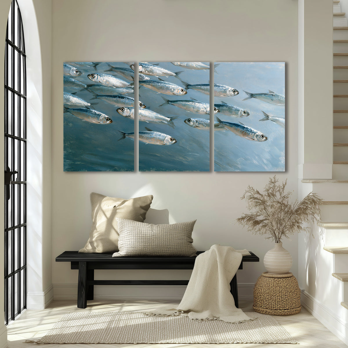 A school of silver fish moving together through cool blue water 3 piece canvas wall art displayed in a entryway