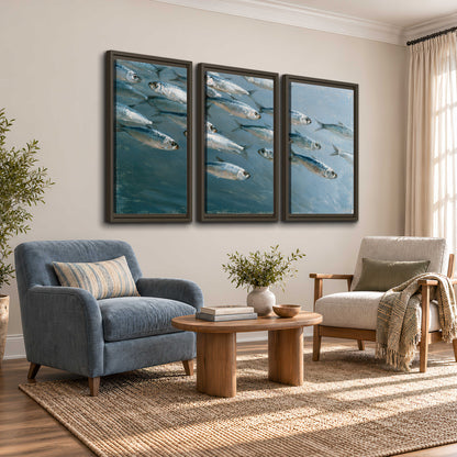 A school of silver fish moving together through cool blue water 3 piece framed canvas wall art styled in an interior