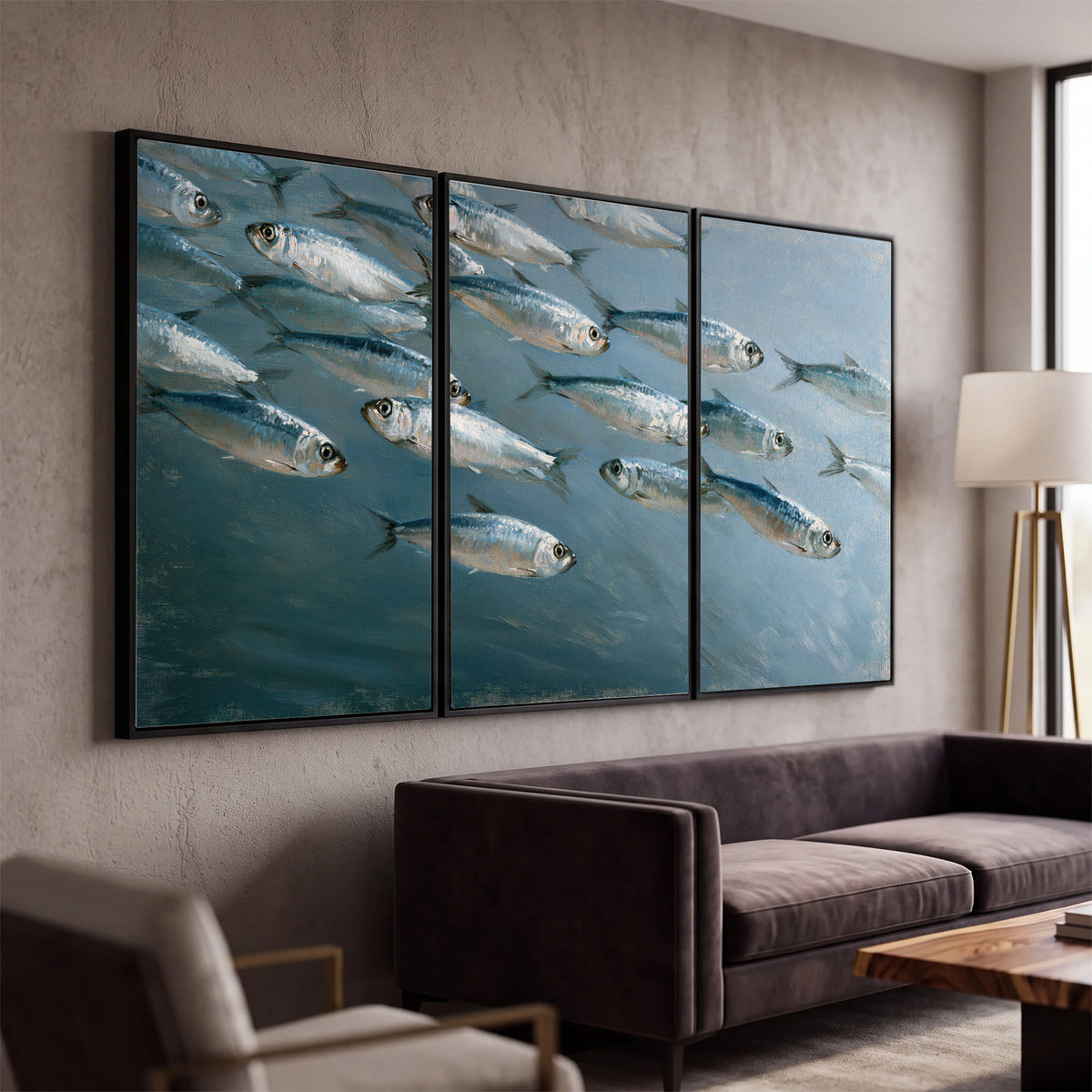 A school of silver fish moving together through cool blue water 3 piece framed canvas wall art displayed in a modern living room