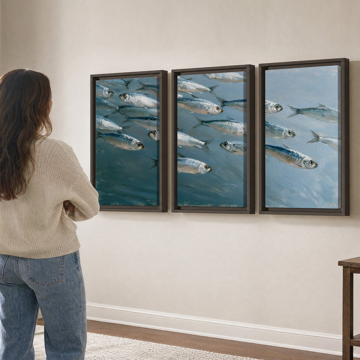 A school of silver fish moving together through cool blue water 3 piece framed canvas wall art three panel arrangement on a wall