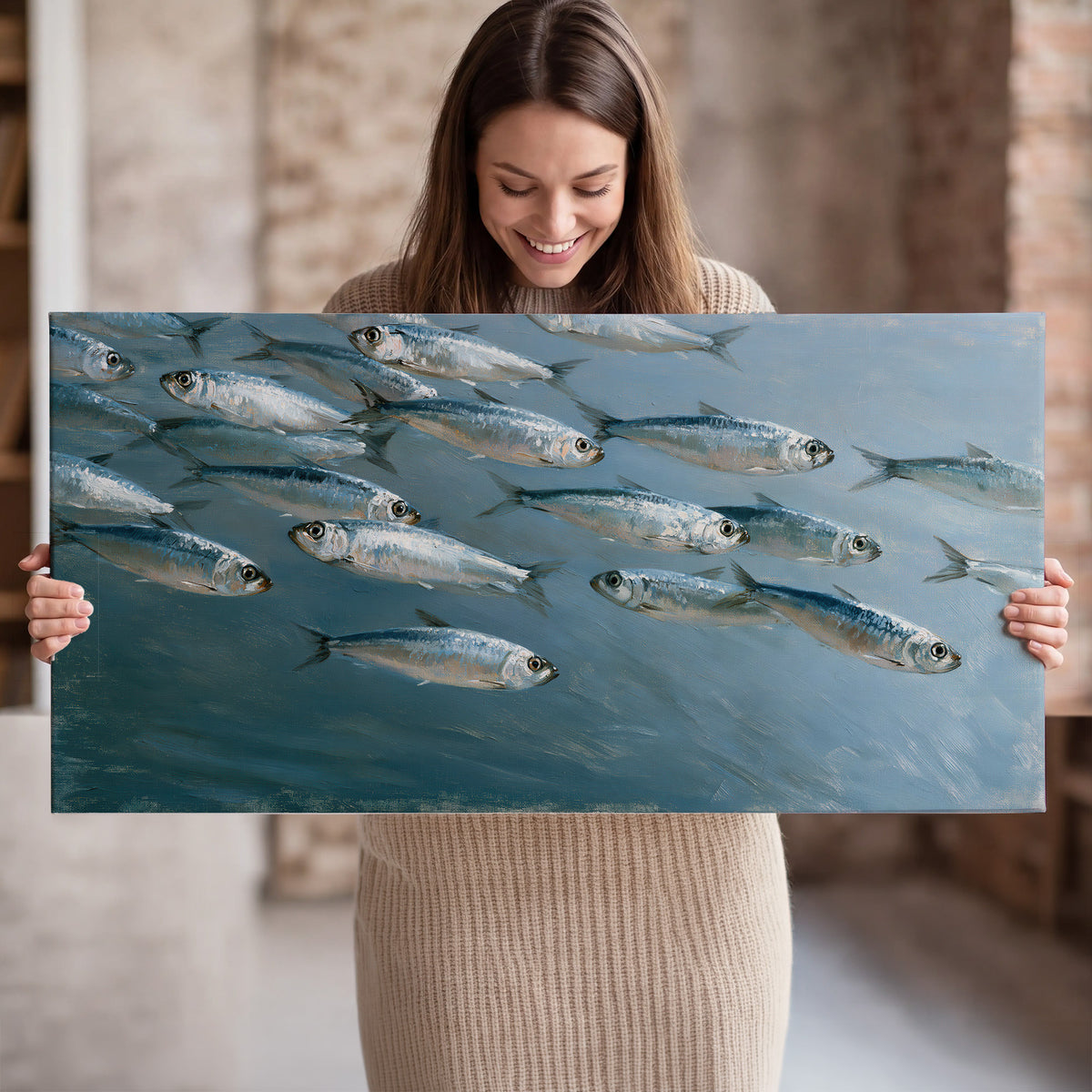 A school of silver fish moving together through cool blue water single canvas wall art held in hands